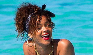 Rihanna Sunbathes on Surfboard in Black Thong Bikini