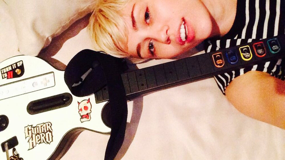 Miley Cyrus Skips The 2014 Grammys Plays Guitar Hero At Home Pic Us Weekly 6203
