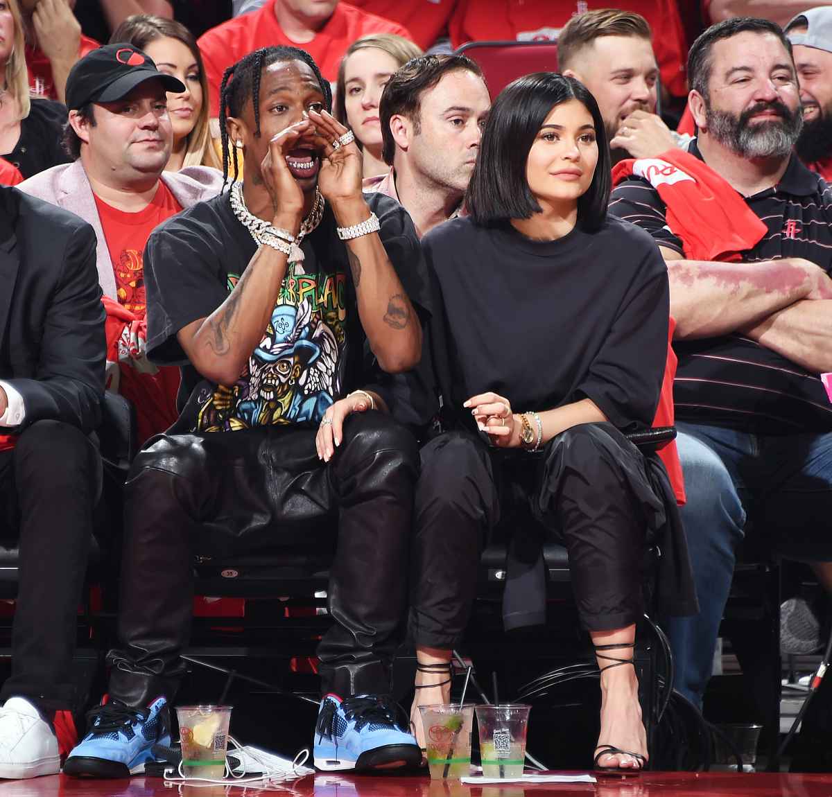 Kylie Jenner, left, and Travis Scott walks to their seats during the second  half in Game 2 of a first-round NBA basketball playoff series between the  Houston Rockets and the Minnesota Timberwolves