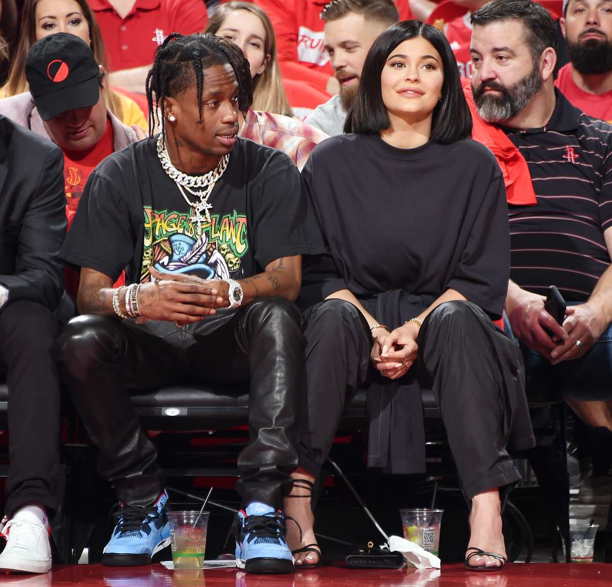 Kylie Jenner, left, and Travis Scott walks to their seats during the second  half in Game 2 of a first-round NBA basketball playoff series between the  Houston Rockets and the Minnesota Timberwolves