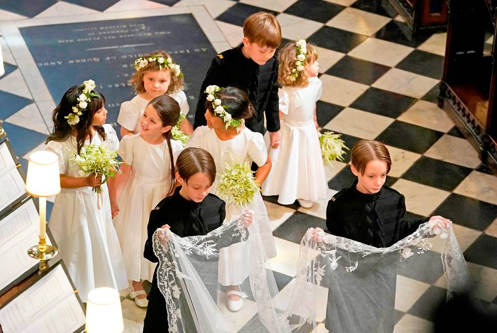 Bridesmaids and Page Boys, including John and Brian Mulroney, walk behind US actress Meghan Markle during her wedding to Britain's Prince Harry, Duke of Sussex in St George's Chapel, Windsor Castle on May 19, 2018.