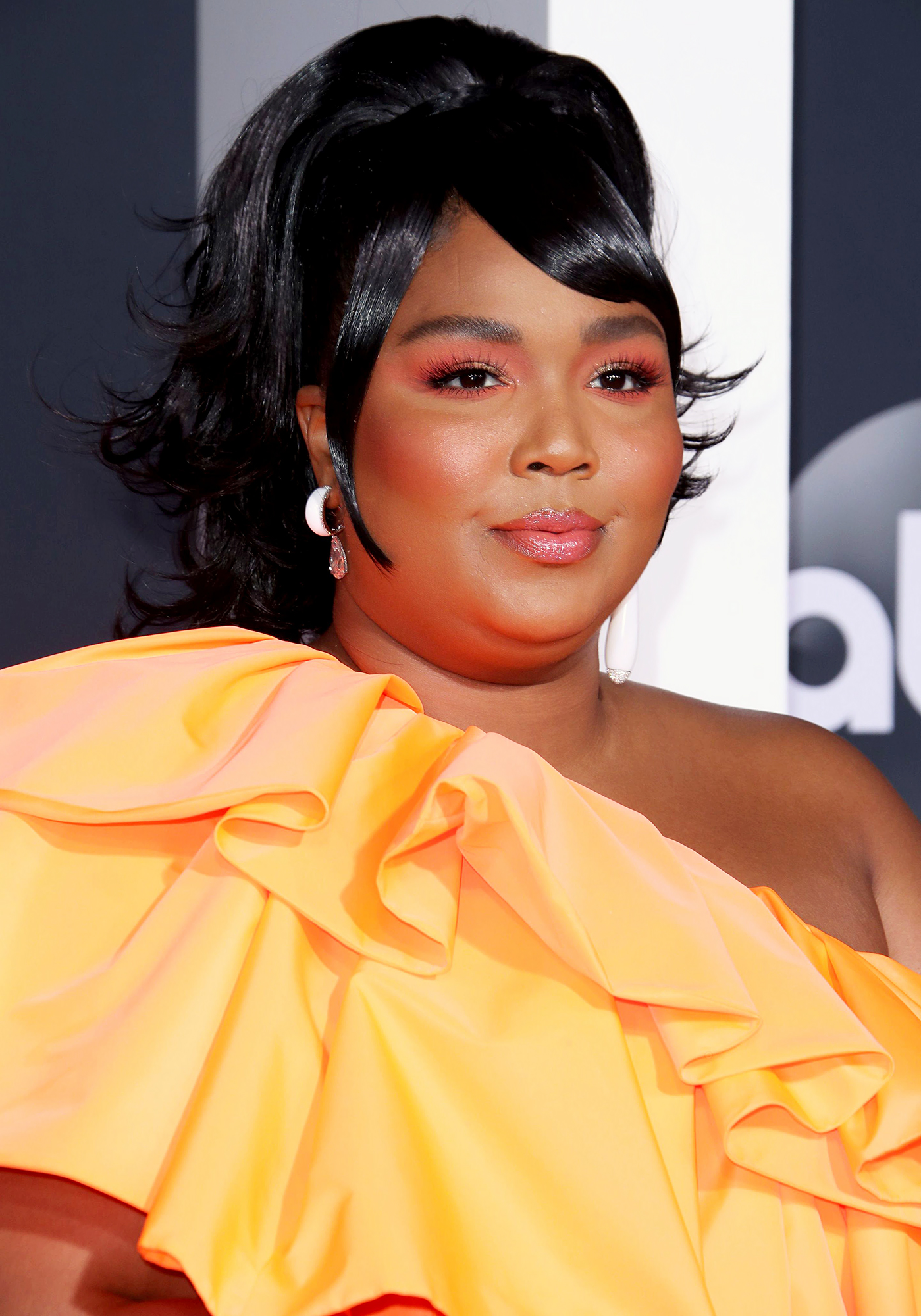 Lizzo Takes Valentino Purse to the AMAs, Spawning Memes