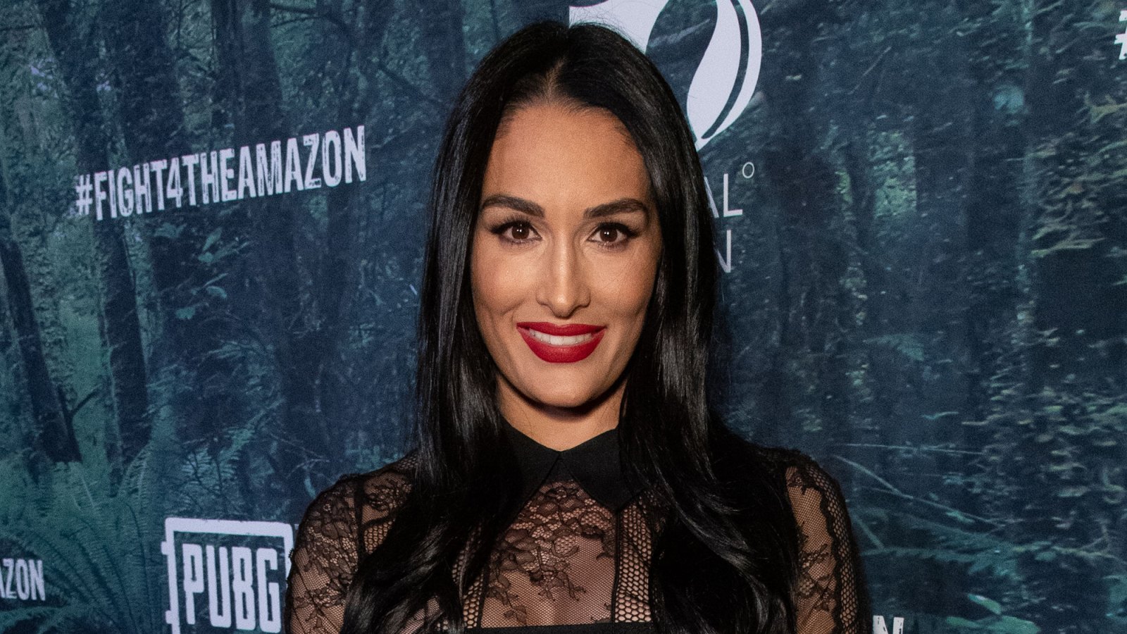 Nikki Bella touches her growing bump as she puts on loved-up display with  fiance Artem Chigvintsev
