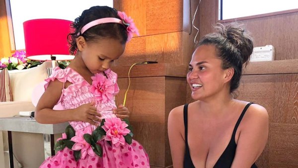Chrissy Teigen Catches Daughter Luna Snacking in the Pantry Batching Suit Pink Dress