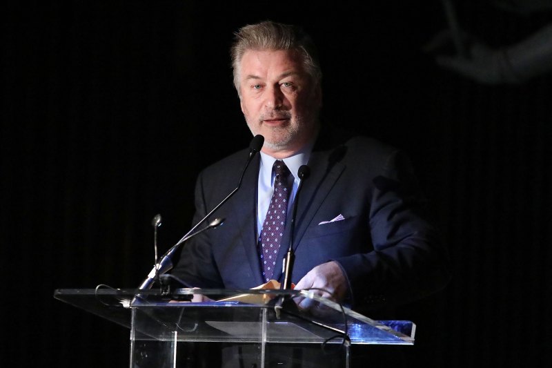 Alec Baldwin speaks at a podium.