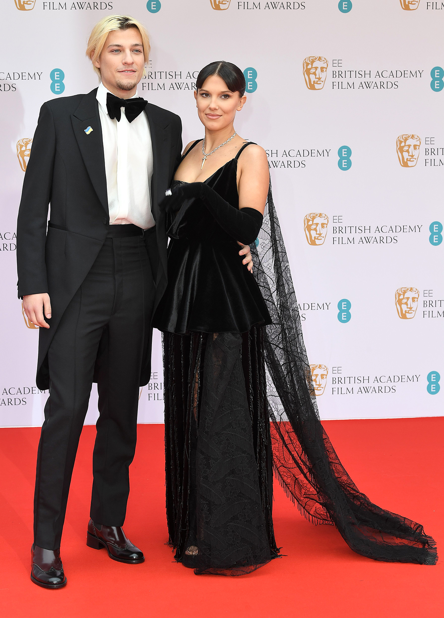 Millie Bobby Brown Attends The BAFTAs 2022 With Boyfriend Jake Bongiovi