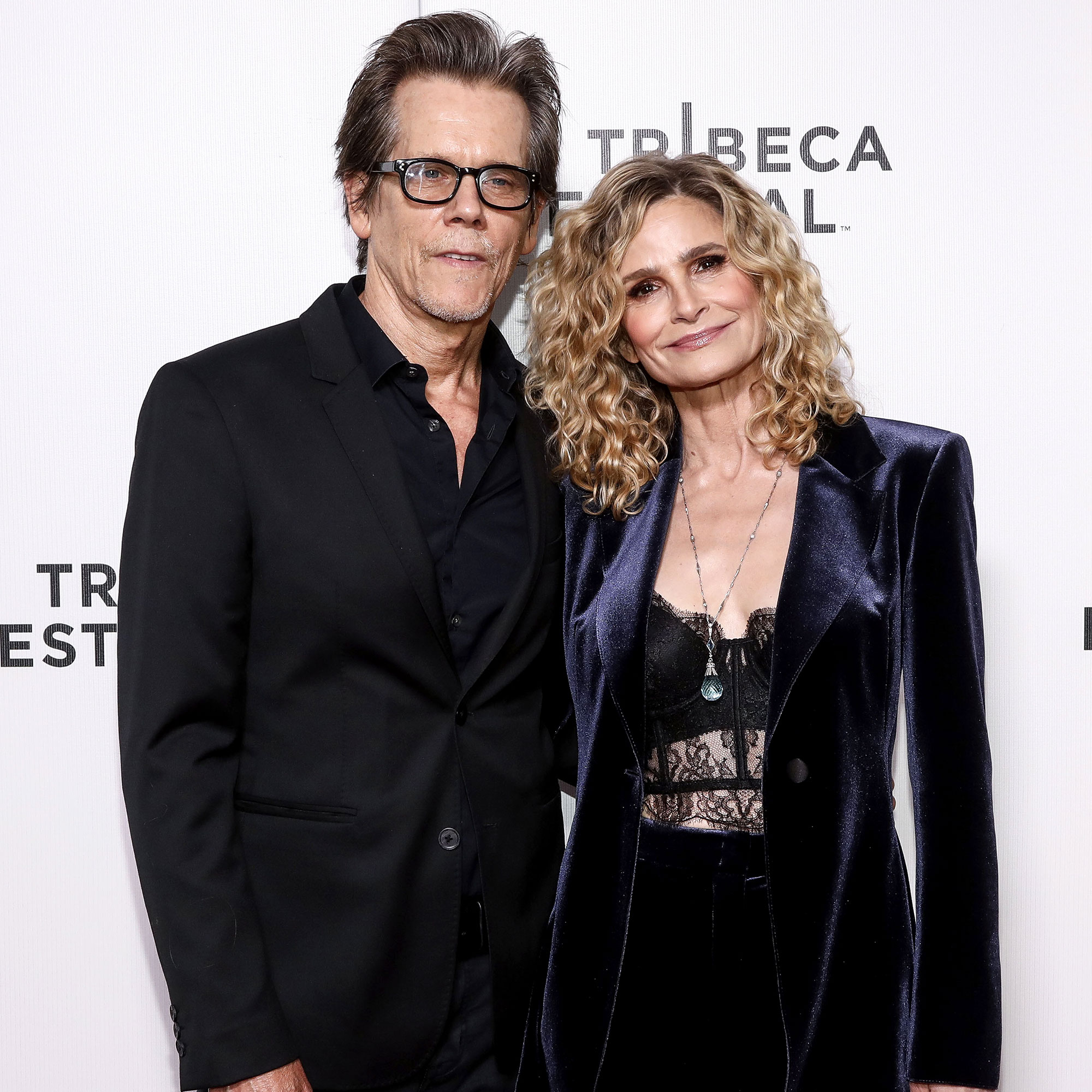 Kyra Sedgwick spices up a trouser suit with sheer lace bodysuit as