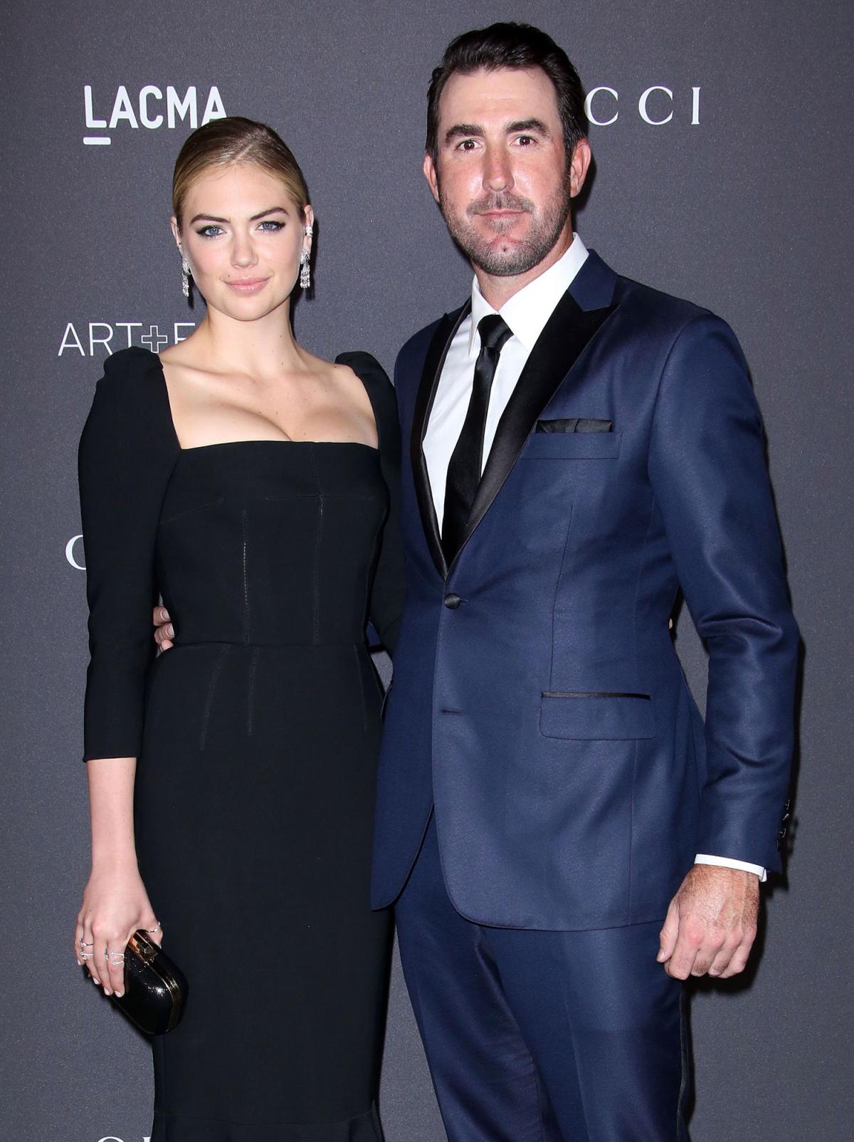 Kate Upton plants a kiss on husband Justin Verlander then he snuggles up to  daughter Genevieve