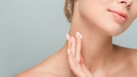 Woman-Applying-Neck-Cream-Stock-Photo