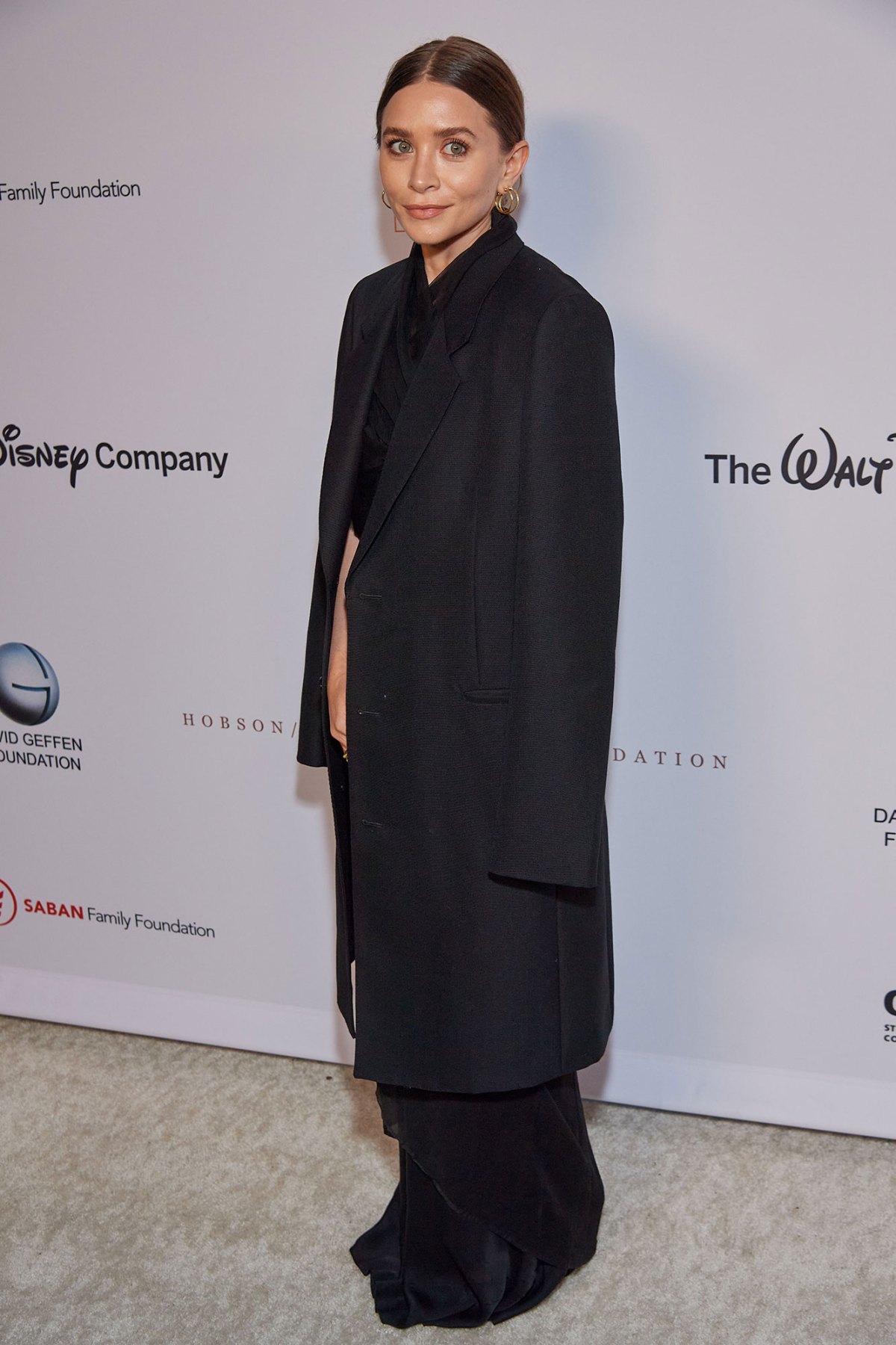 Mary-Kate Olsen keeps warm in an oversized black coat while