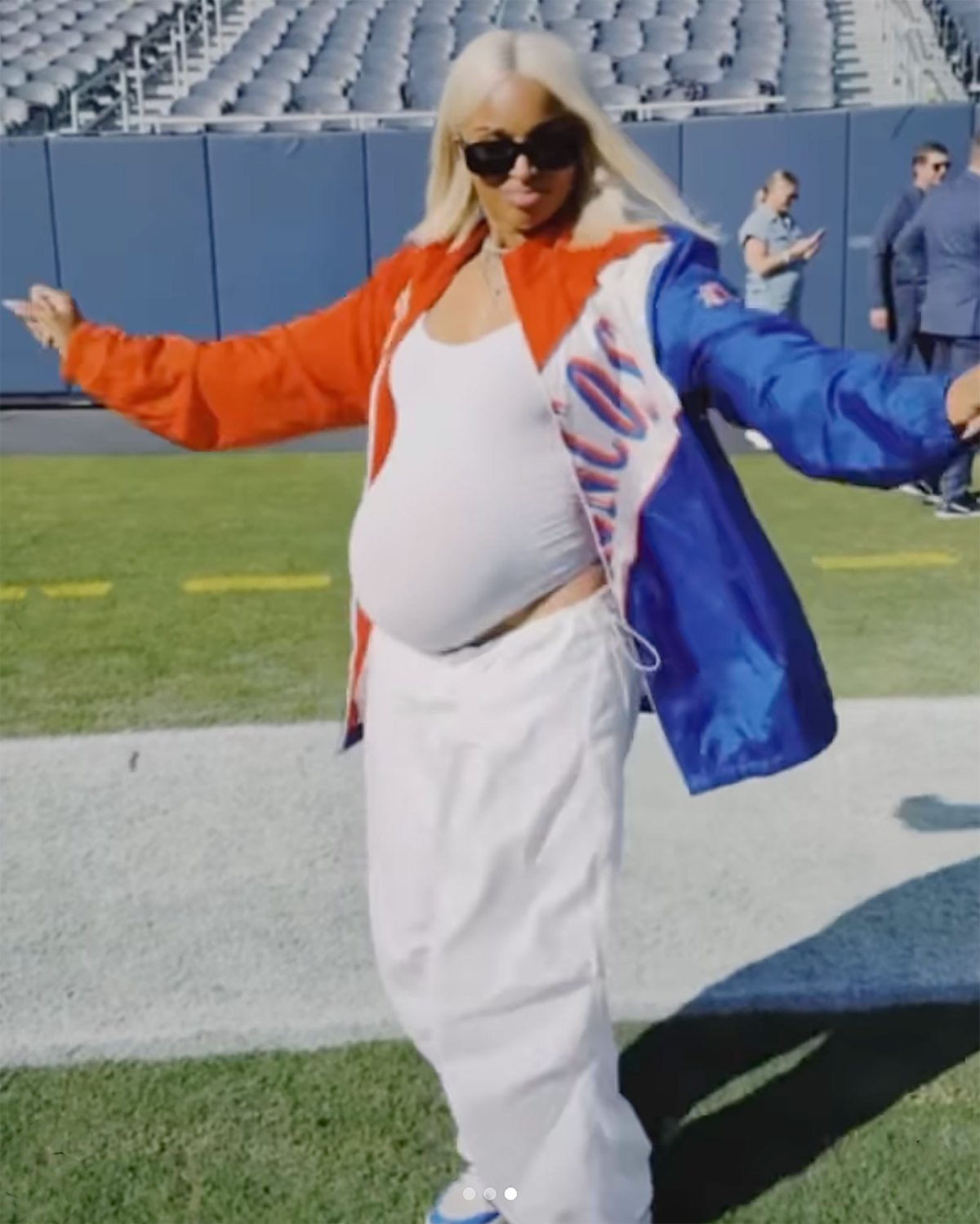 Russell Wilson Cradles Pregnant Ciara's Baby Bump on Football Field