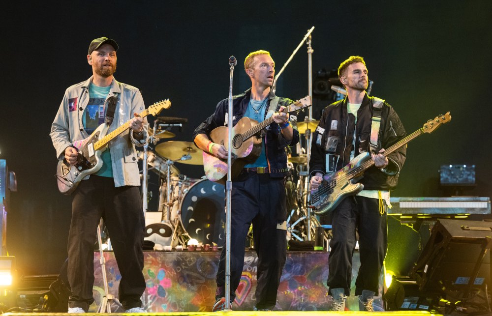 Dakota Johnson Watches Fiance Chris Martins Coldplay Perform at Glastonbury With His 2 Kids
