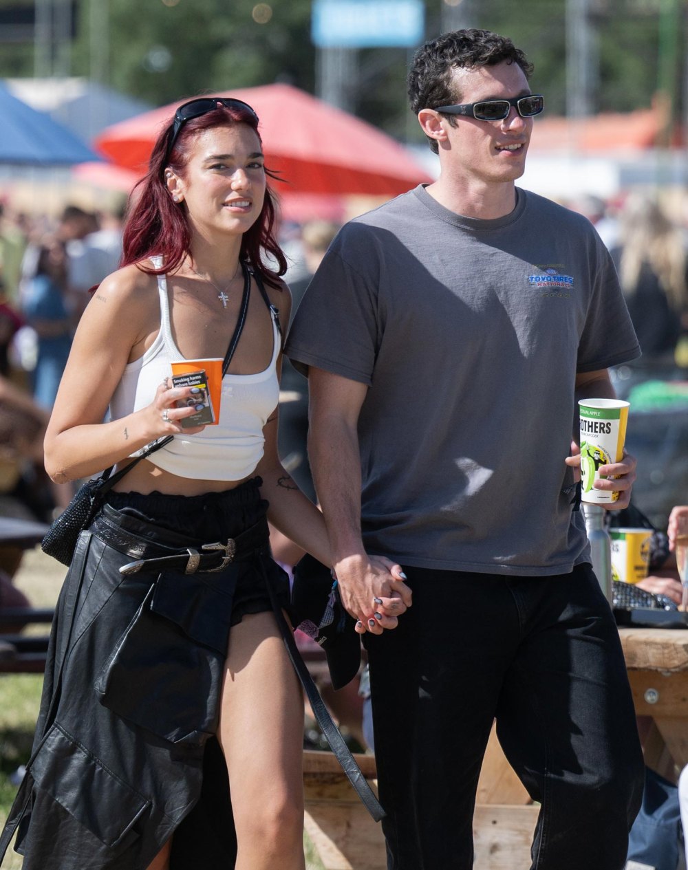 Dua Lipa and Calum Turner cutely hold hands during a date at Glastonbury Festival in the UK