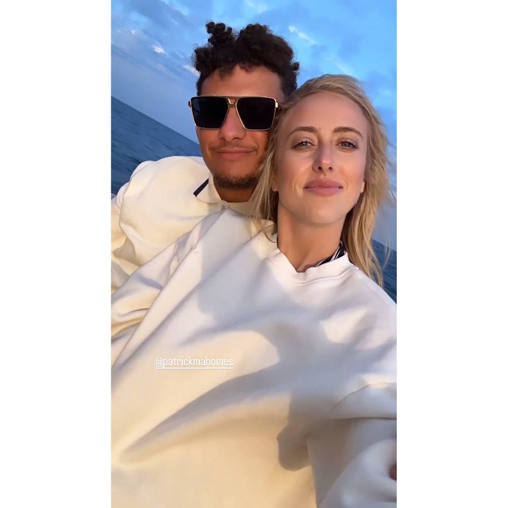 Patrick Mahomes kisses wife Brittany Mahomes on the cheek during a romantic boat ride in Portugal.