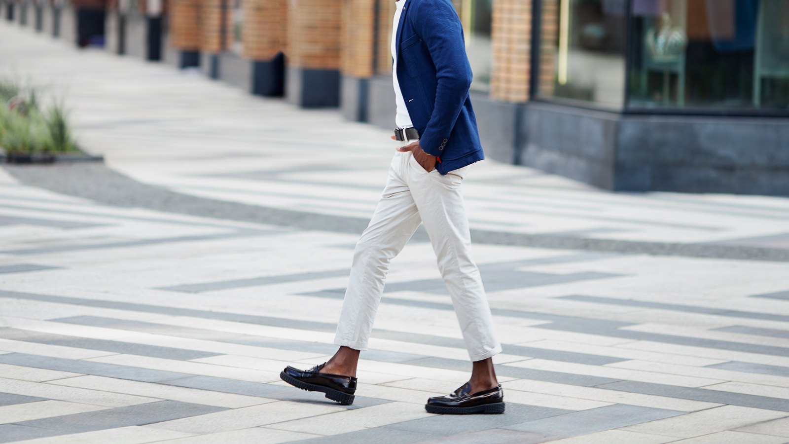 Man walks down the street in loafers.