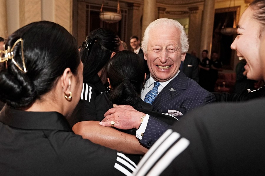 King Charles III Smiles During Healing Hug From New Zealand Rugby Team