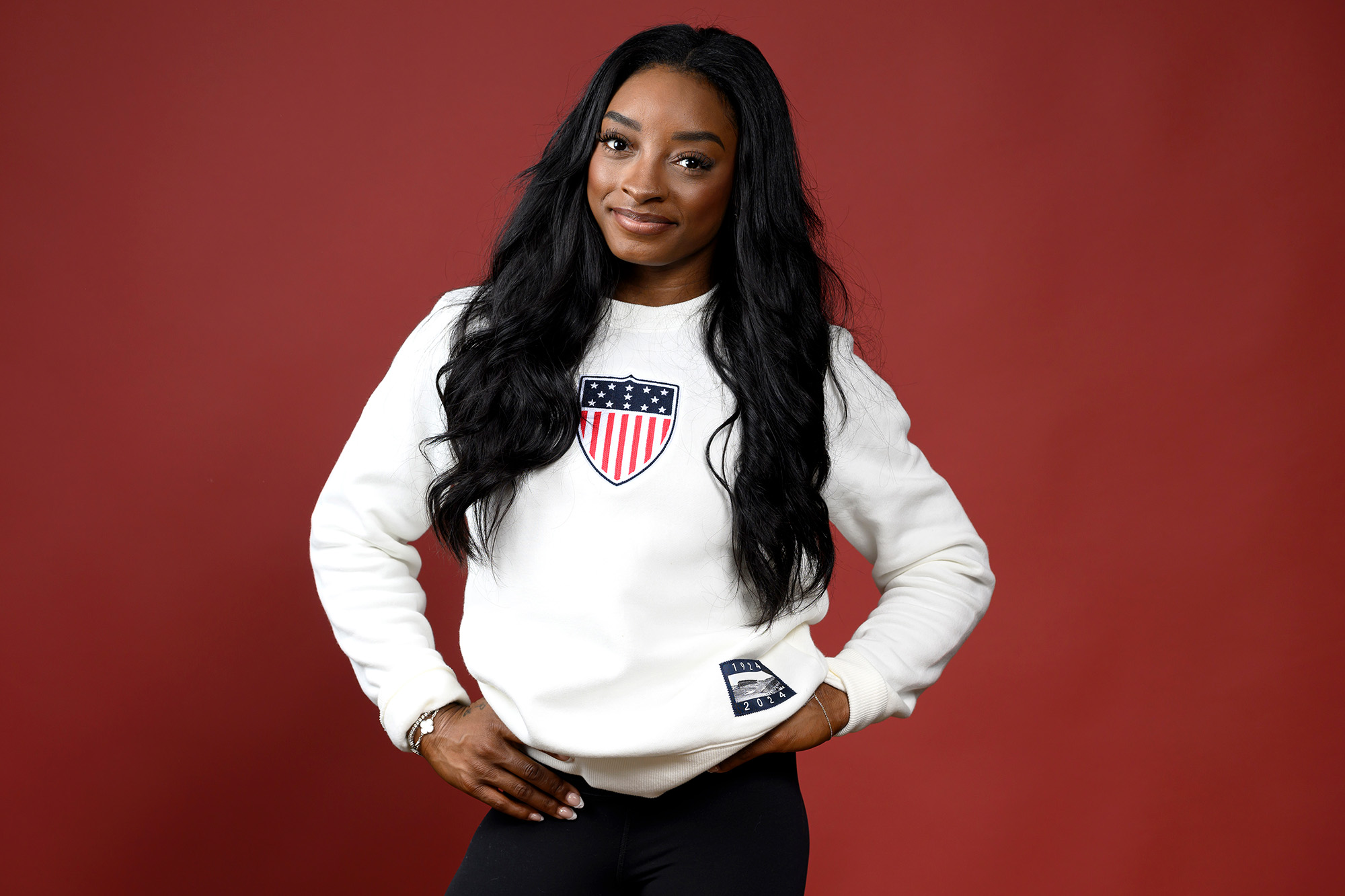 Simone Biles Shows Off Bedazzled GOAT Sweatshirt on Gold Over America Tour