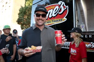 KANSAS CITY, MISSOURI - OCTOBER 05: Travis Kelce serves up Raising Cane's at 2nd Annual Kelce Car Jam in Kansas City on October 05, 2024 in Kansas City, Missouri. (Photo by Kevin Mazur/Kevin Mazur/Getty Images for Raising Cane's )