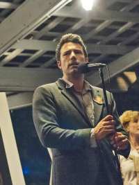 Rosamund Pike (in poster), Ben Affleck, Lisa Banes, David Clennon in Gone Girl