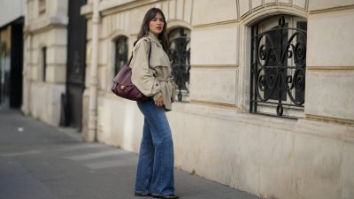 PARIS, FRANCE - OCTOBER 11: Raisa wears a beige cropped trench coat, a burgundy leather Chanel bag, blue straight leg denim pants / jeans, black leather shoes, during a street style fashion photo session, on October 11, 2026 in Paris, France. (Photo by Edward Berthelot/Getty Images)